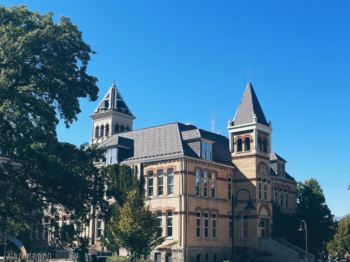 A college building with two towers against a clear sky
