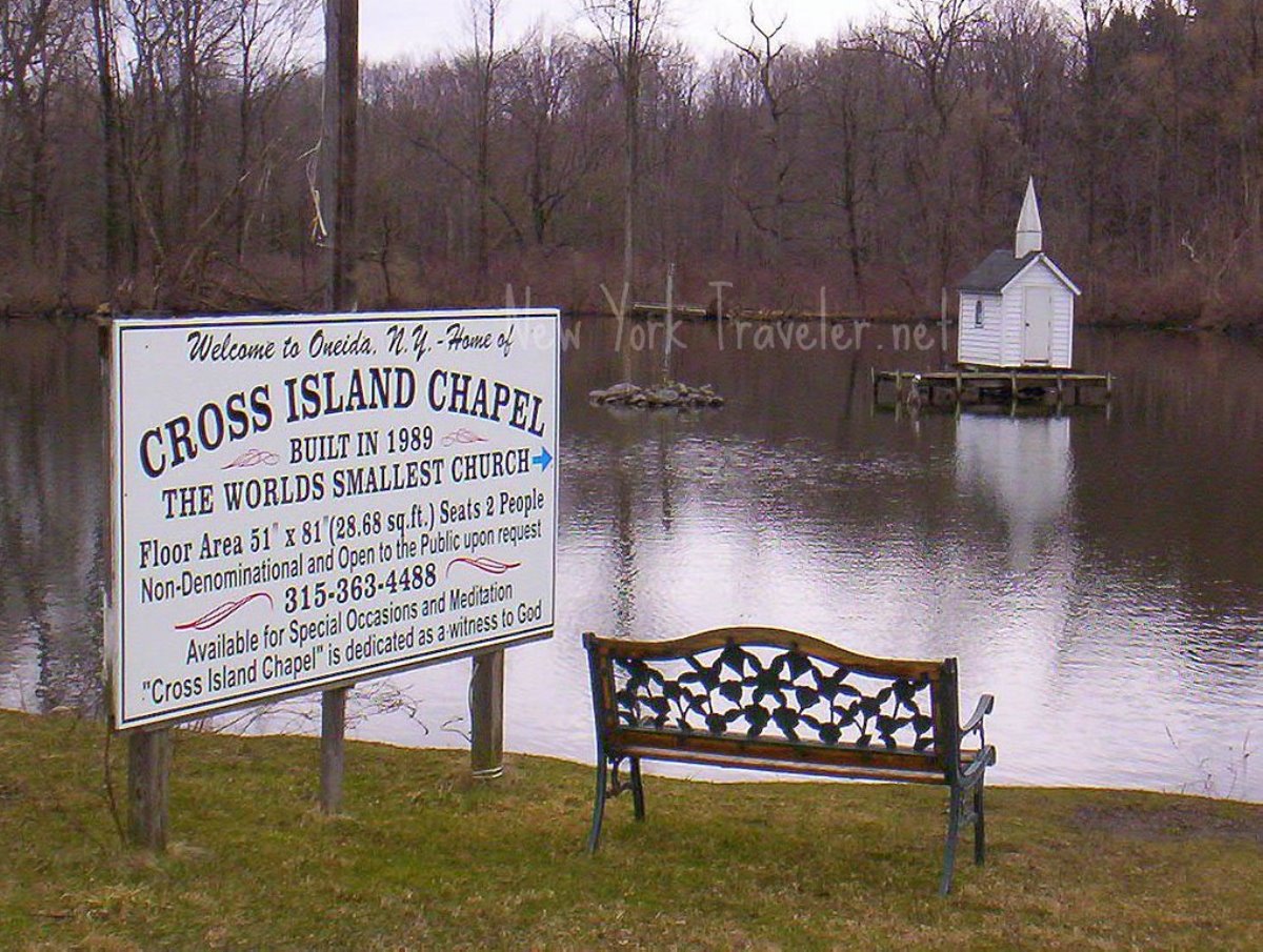 A small white chapel in the middle of a pond, a sign in the foreground explaining this