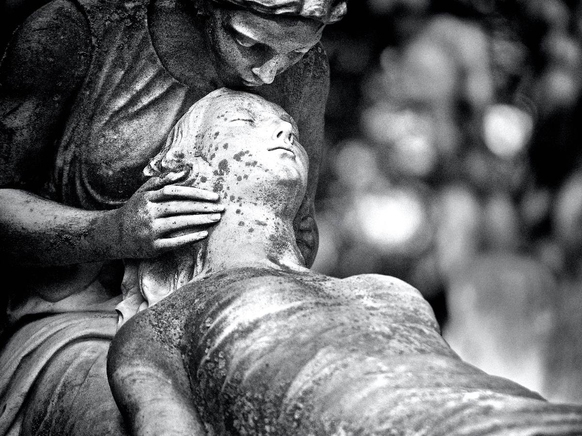 A statue of a woman kissing another woman in repose