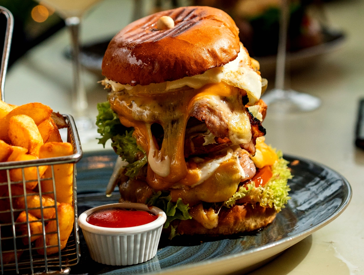 A cheeseburger with too many layers and too much cheese