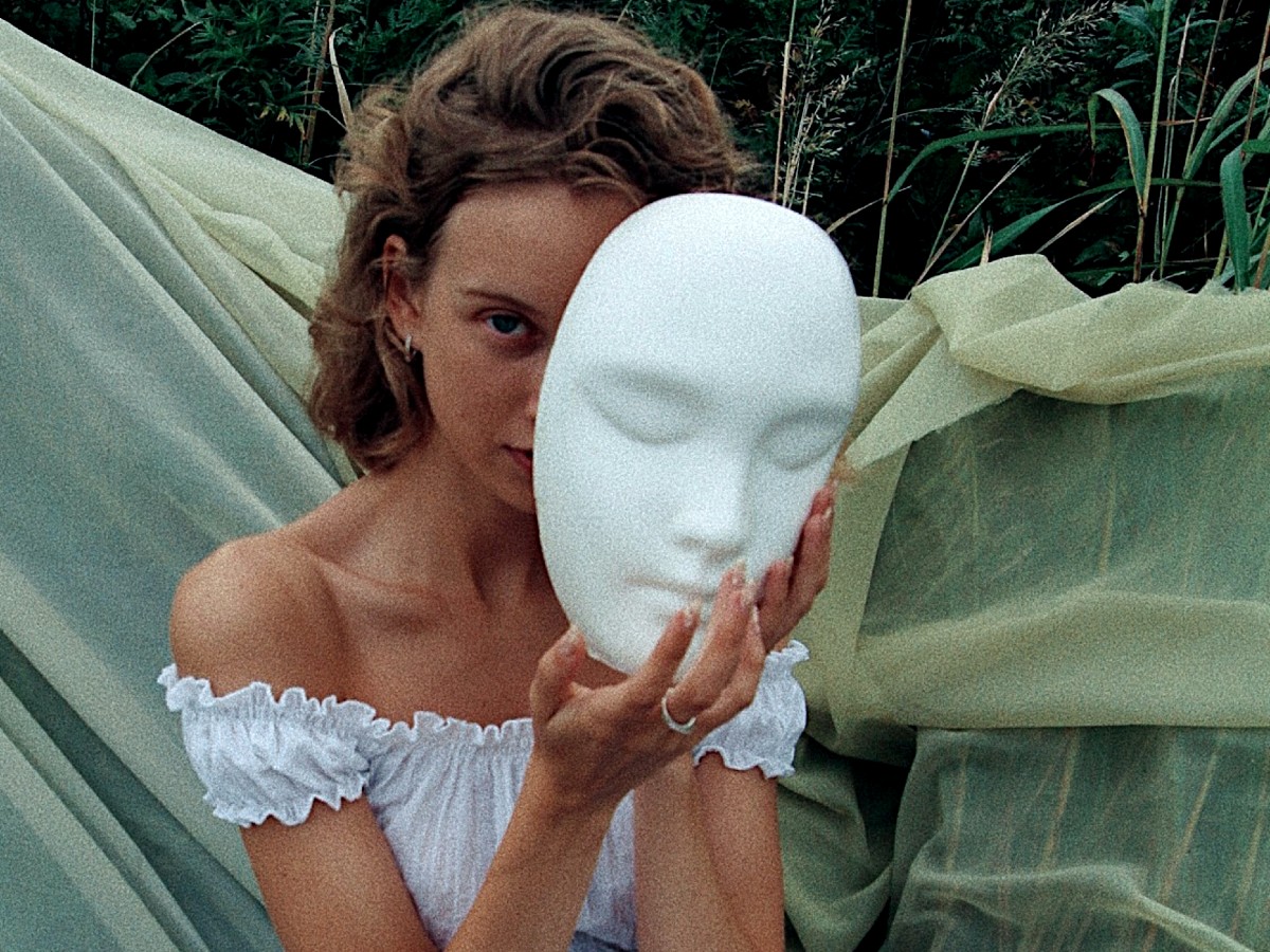 A woman behind a mask